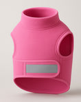 Load image into Gallery viewer, Pink fleece dog vest with high collar, arm holes, and gray reflective strip on front panel, displayed against neutral background.