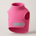 Load image into Gallery viewer, Pink fleece dog vest with high collar, arm holes, and gray reflective strip on front panel, displayed against neutral background.
