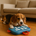 Load image into Gallery viewer, A beagle plays with a blue puzzle toy on a wooden floor in front of a beige sofa, with treats visible in an orange compartment.
